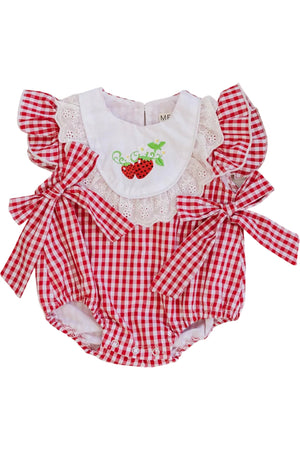 A red and white gingham baby romper features ruffled sleeves, a white eyelet lace collar adorned with strawberries, and charming side bows for a delightful, vintage-inspired look. Ideal for toddlers.