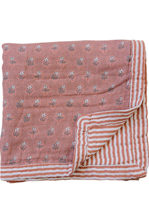 Pink floral and striped muslin crib quilt, folded, showcasing soft cotton fabric with vintage-inspired design.