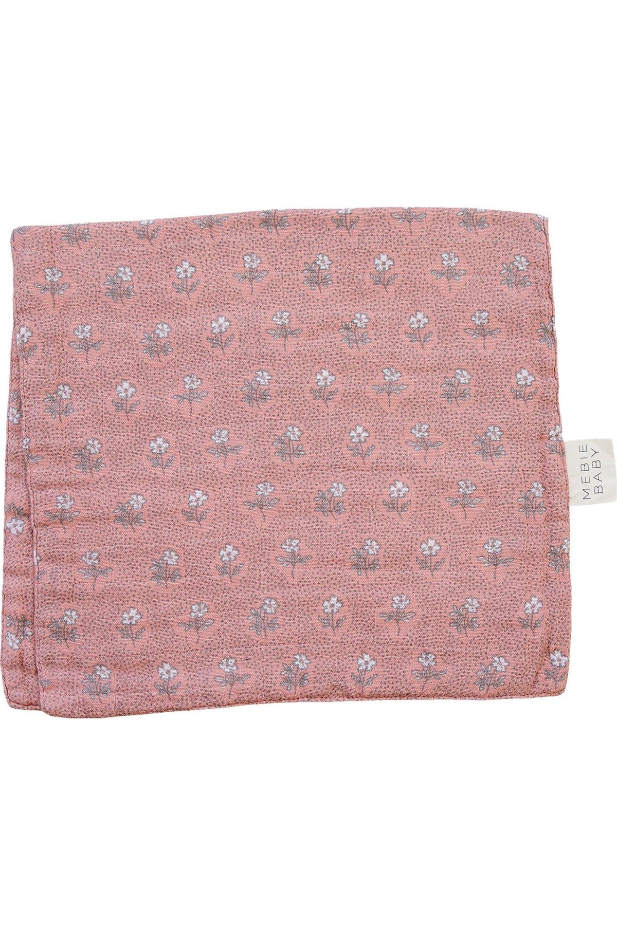 A pink muslin burp cloth with a white floral pattern and Mebie Baby tag on the side.