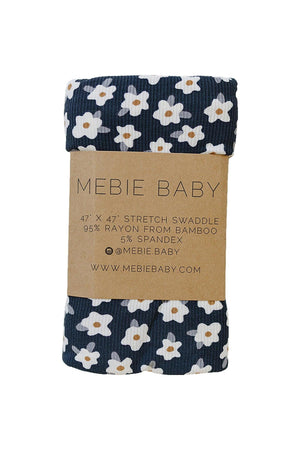 Navy stretch swaddle from Mebie Baby featuring a floral design, made of 95% bamboo rayon and 5% spandex.