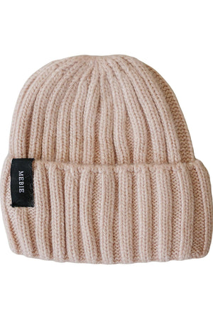 Light pink chunky knit beanie made from 100% angora wool, featuring a folded cuff and a small brand label.