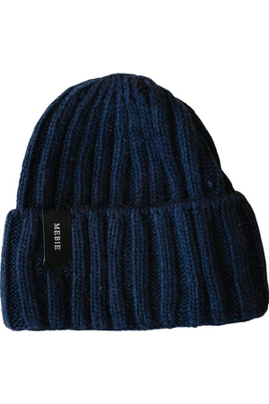 Navy blue chunky knit beanie made of 100% angora wool, featuring a folded cuff and a Mebie label.