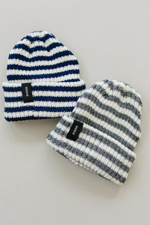 Two striped beanies are displayed, one in navy blue and white, and the other in gray and white, both with.