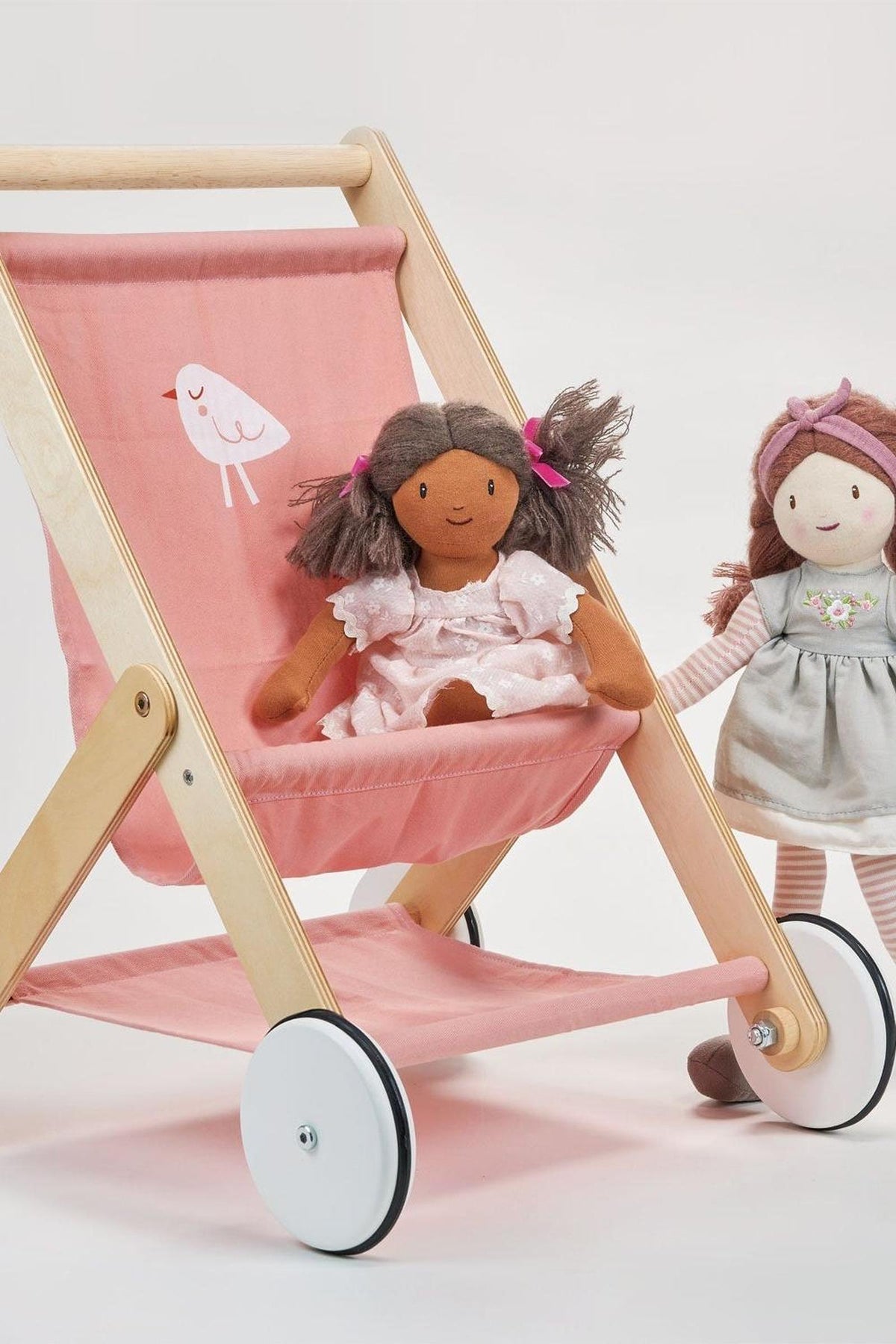 Wooden baby doll stroller with pink fabric seat and wheels, featuring two plush dolls. Eco-friendly, safe play.