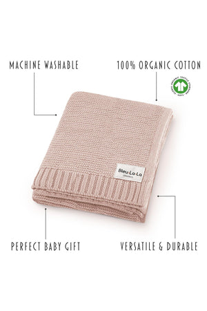 A folded pink knit blanket labeled Bleu-La-La Organics, made from 100% organic cotton, with eco-friendly features.