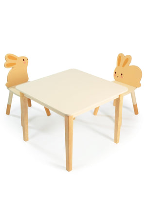 Child-sized table with two bunny-eared chairs, made from light wood and white surfaces. Eco-friendly toddler furniture set.