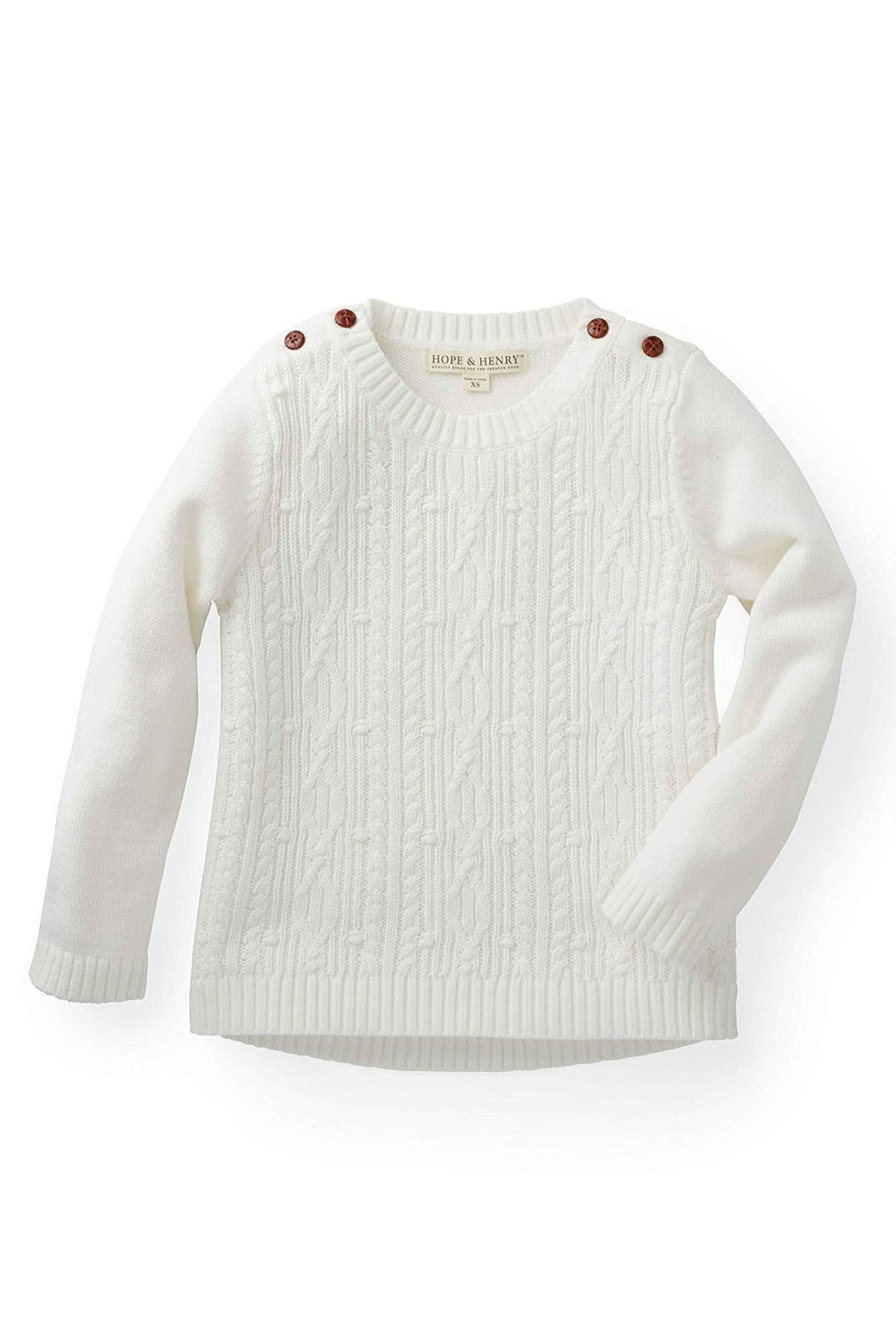 White cable knit sweater for girls by Hope & Henry, featuring faux leather shoulder buttons and soft, organic cotton material.