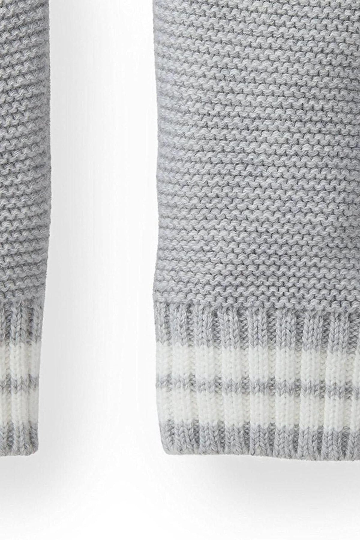 Close-up of the cuff of a gray heather cardigan, featuring a textured knit design with a striped rib trim in white. Made from soft, organic cotton for comfort.