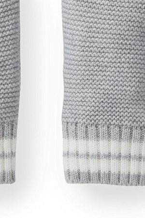 Close-up of the cuff of a gray heather cardigan, featuring a textured knit design with a striped rib trim in white. Made from soft, organic cotton for comfort.