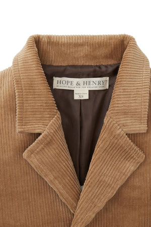 Close-up of a Hope & Henry organic corduroy blazer in medium brown, featuring a classic collar and soft texture. The label indicates size XS, emphasizing its quality and sustainable material.