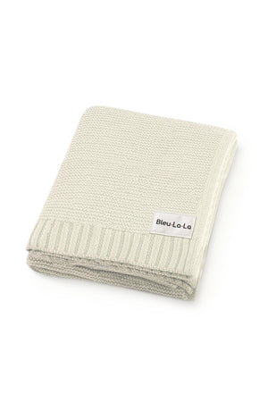 A folded, light gray knit baby blanket with a Bleu La La label, featuring a ribbed edge design.