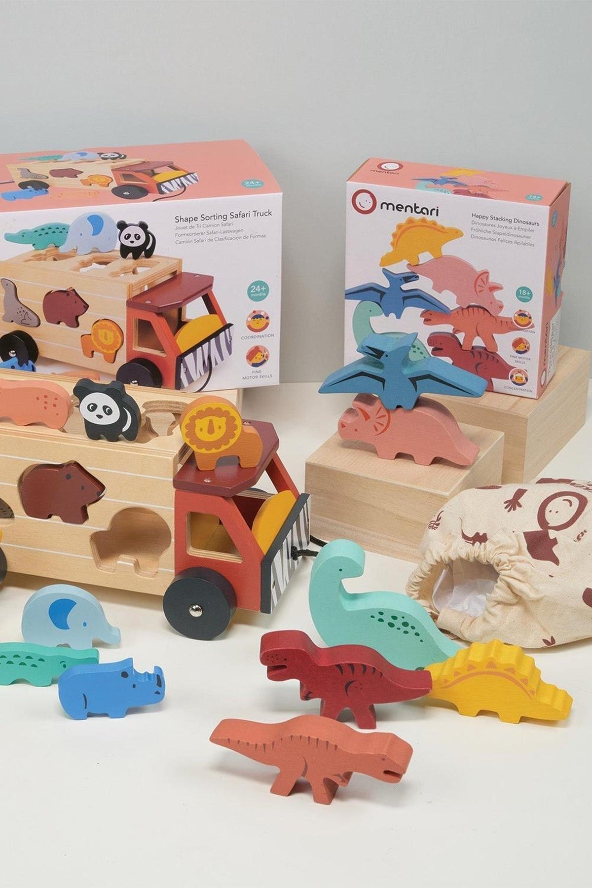 Mentari Wooden Toys feature a shape sorting safari truck and stacking dinosaurs, crafted from colorful, eco-friendly wood.