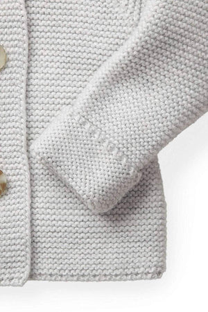Light gray organic cotton sweater featuring a textured seed stitch and a cozy fit. The design includes a faux fur trim and stylish button details, perfect for babies.
