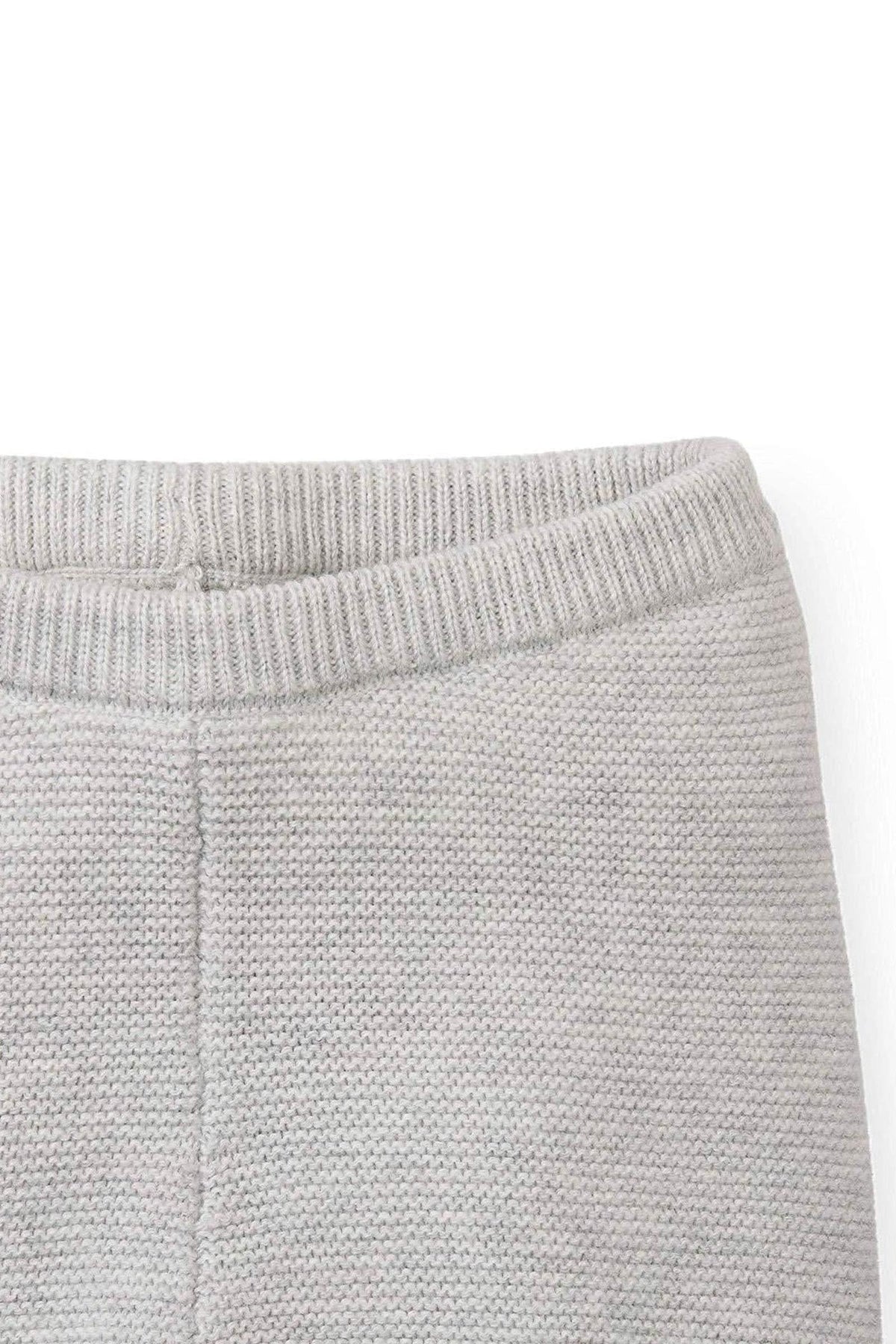 Close-up of the waistband of light gray pants made from soft organic cotton. The texture features a ribbed finish, adding comfort and style for babies.