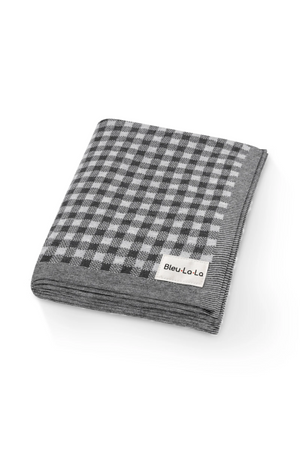 A folded checkered knit blanket in gray tones, labeled Bleu La La, made from soft, breathable cotton fabric.