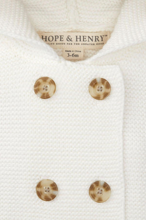 Close-up of a soft white seed stitch knit hooded sweater by Hope & Henry, featuring double-breasted buttons and a size.