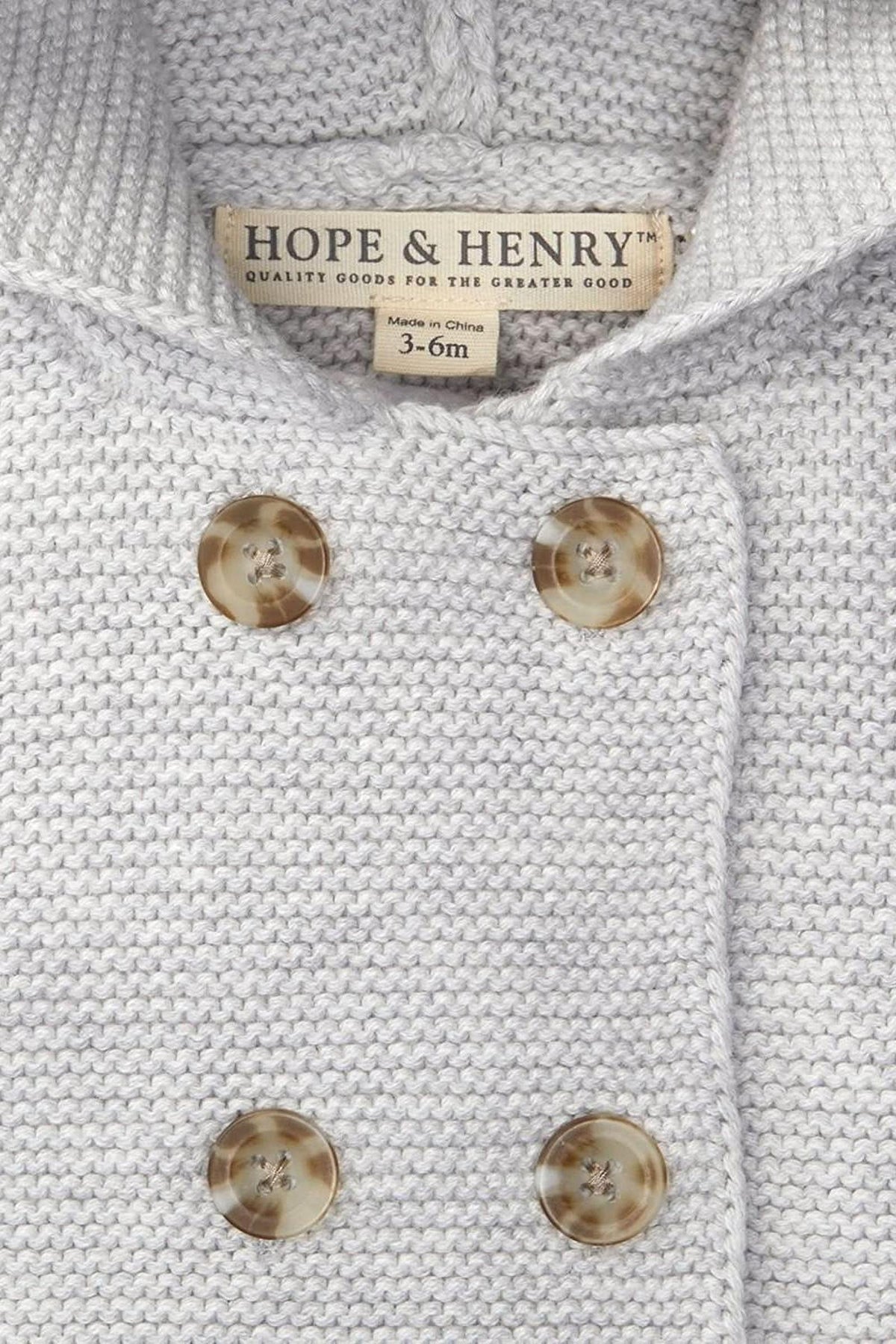 Light gray heather seed stitch knit hooded sweater by Hope & Henry, featuring a double-breasted button front. Made from organic cotton, its designed for babies aged 3-6 months.