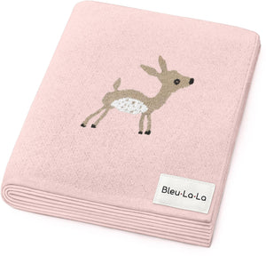 A soft, pink knit blanket featuring a whimsical deer design, made from 100% OEKO-Tex certified Pima cotton. Ideal for newborns, it offers a gentle and breathable embrace.