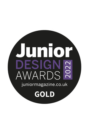 A round logo displaying Junior Design Awards 2022 in bold white and purple text on a black background, highlighting the award status as GOLD.