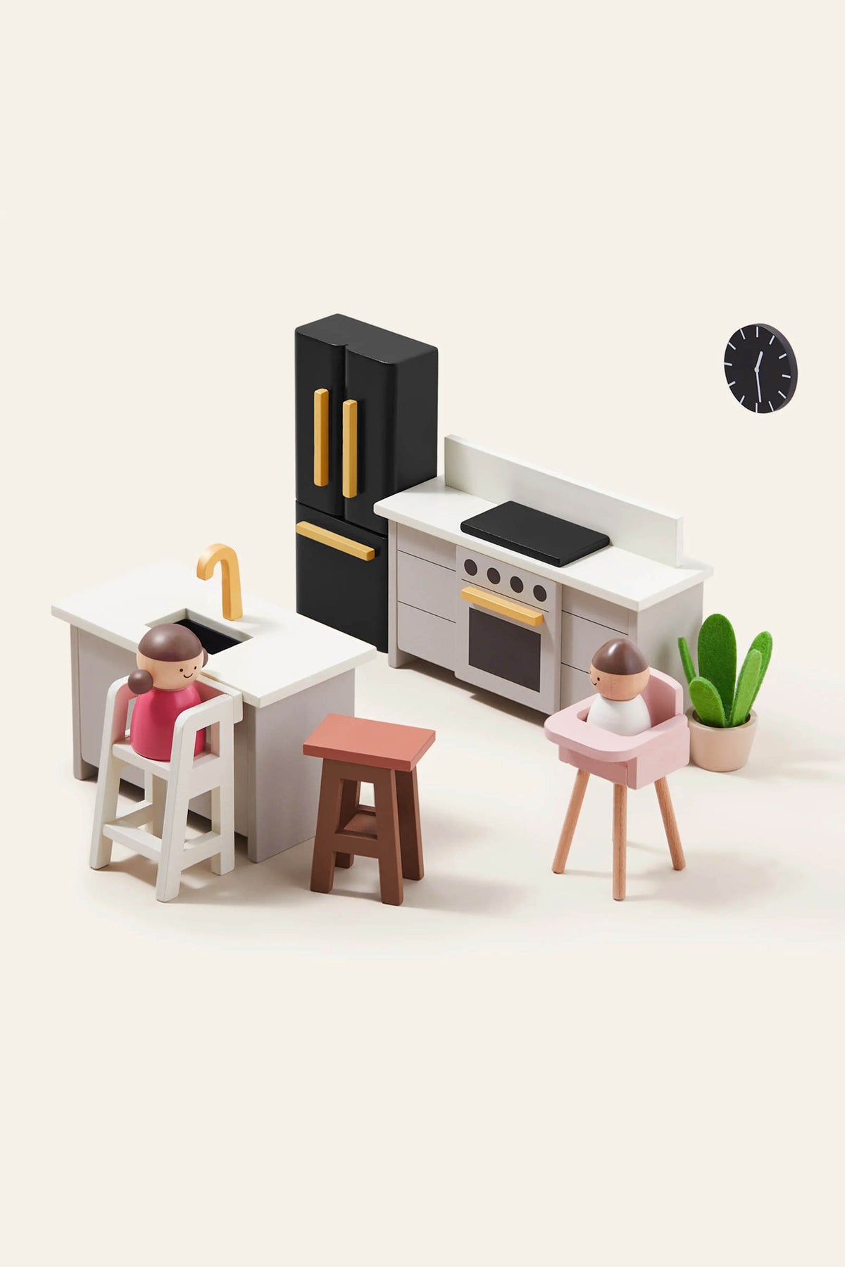 A modern kitchen playset features a black refrigerator, white cabinetry, and wooden stools. Two toy figures are positioned at a high chair and a stool, enhancing imaginative play.