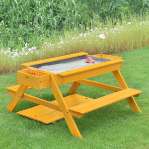 Bright yellow wooden picnic and sand table set on green grass, featuring a sandbox area beneath a removable top. Ideal for outdoor play, encouraging creativity and hands-on discovery for toddlers.