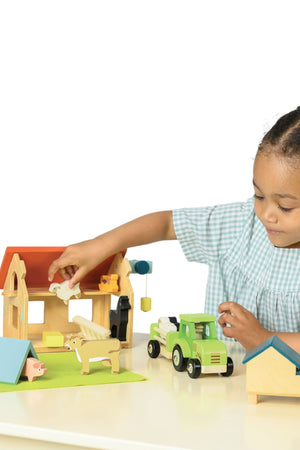 Child playing with a wooden toy set on a white background