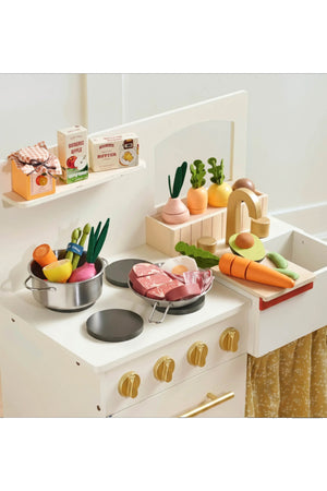 A wooden toy kitchen set features colorful play food, including vegetables and meats, alongside accessories like pots and pans. The eco-friendly materials encourage imaginative cooking play for children.