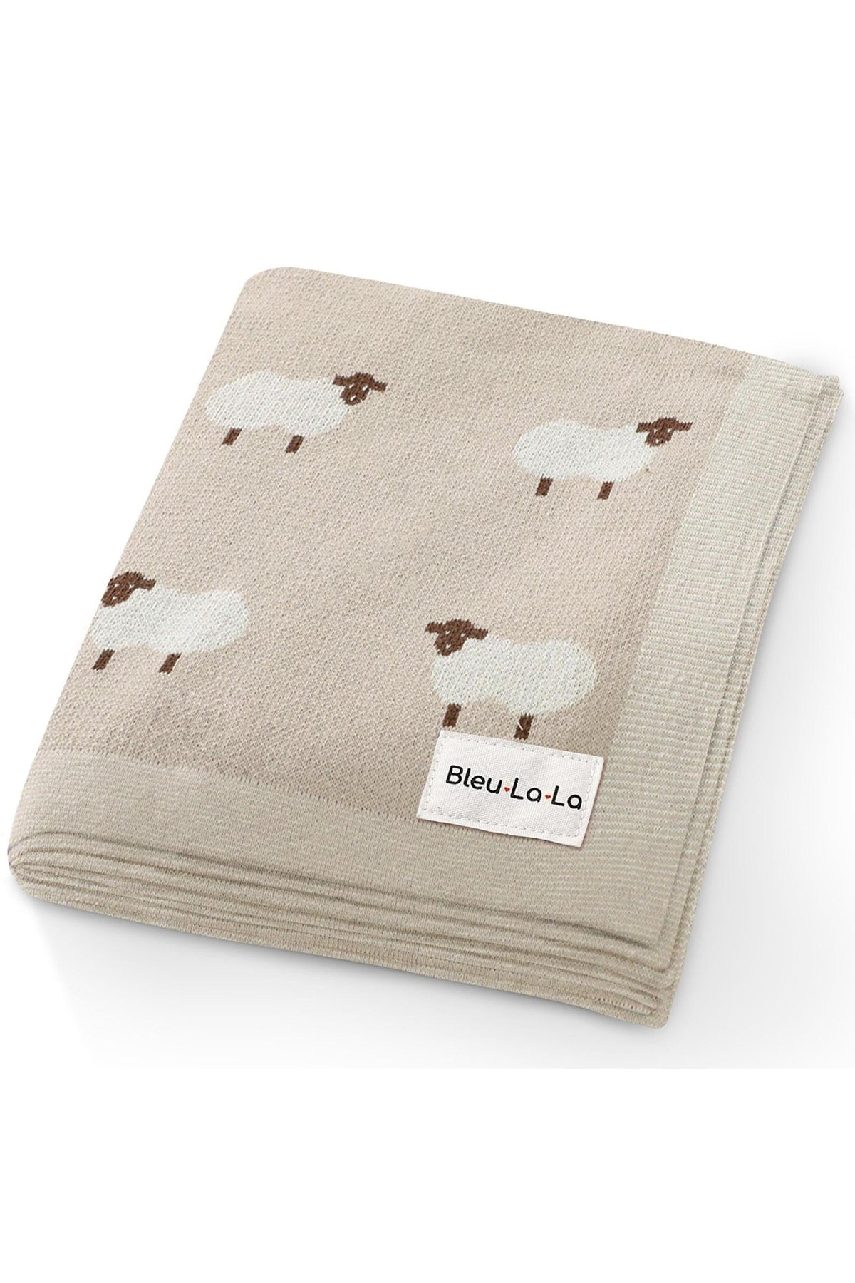 Beige knit blanket with sheep pattern, featuring a Bleu La La label on the corner.