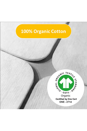 Close-up of white organic cotton pads with a 100% Organic Cotton label and GOTS certification logo.
