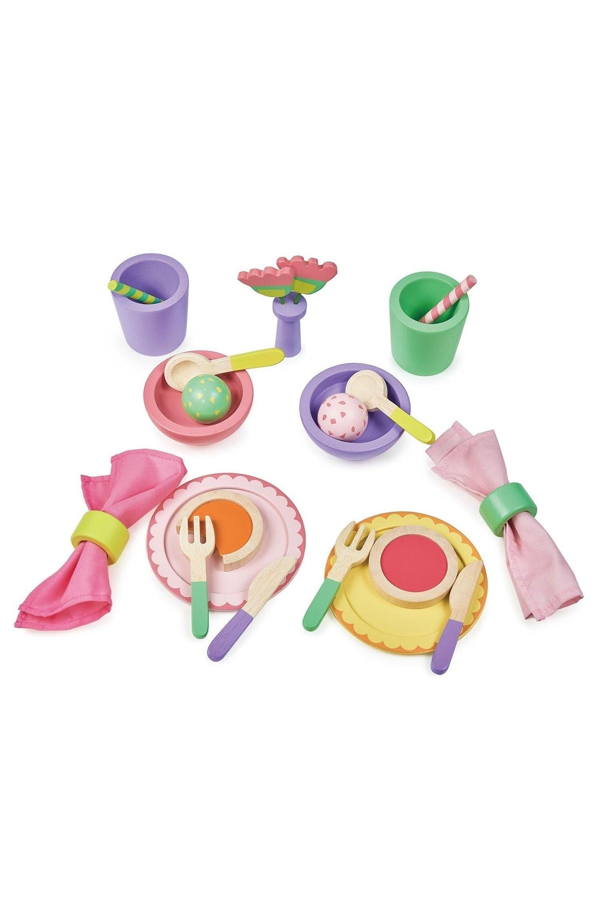 Colorful wooden toy lunch set with plates, bowls, cups, utensils, and napkins, in bright pink, green, and purple.