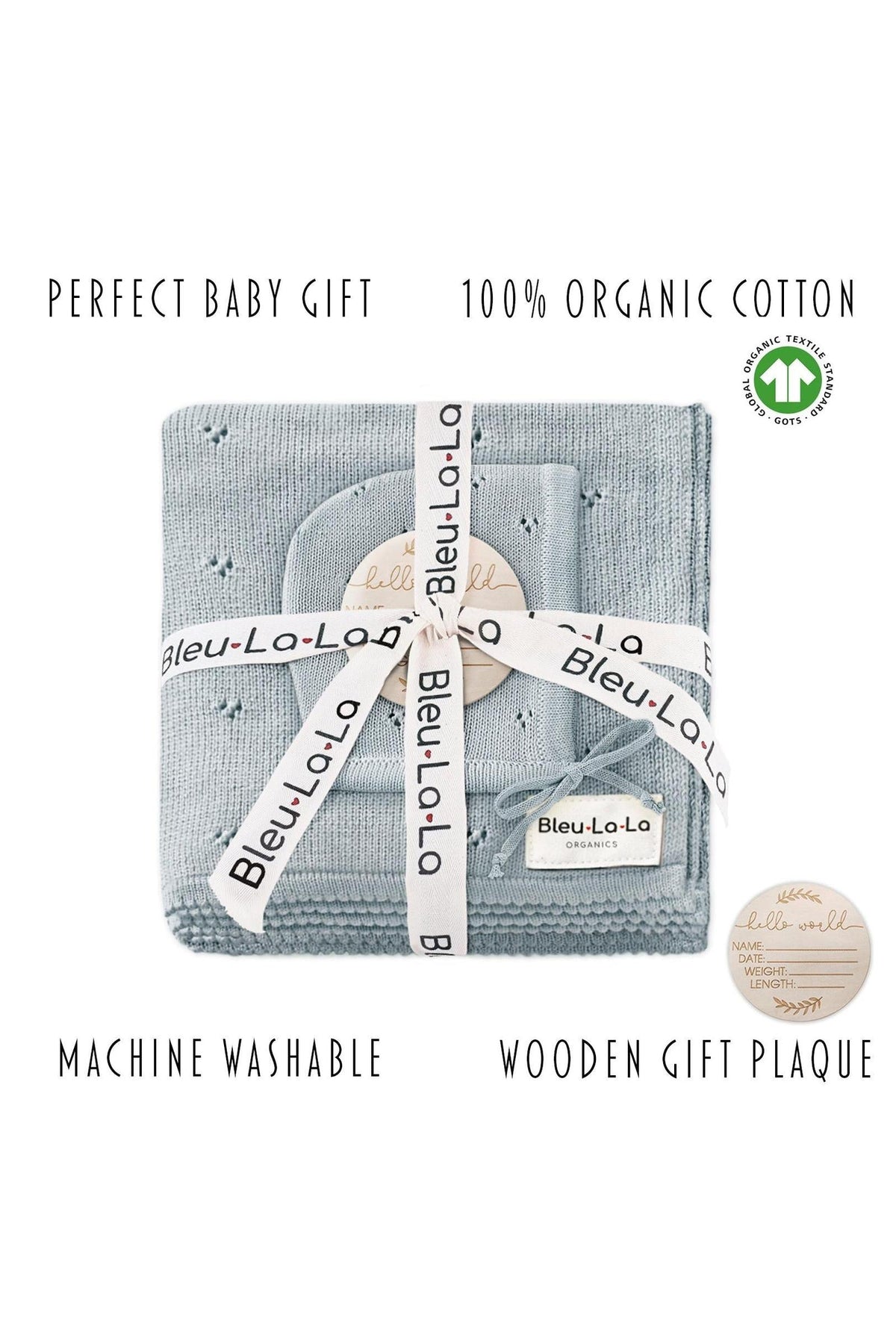 A neatly folded blue pointelle blanket and hat set, wrapped with branded ribbon, includes a wooden gift plaque.