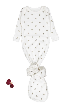Cream-colored baby gown featuring a playful leaf pattern, made from 95% cotton for comfort. The gown has long sleeves and a tie bottom for easy diaper changes and snug fit.