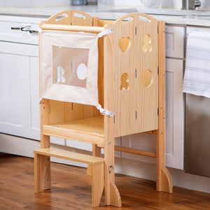 Laurel 4-in-1 Foldable Kitchen Tower in natural wood features a step stool, slide, and chalkboard. It includes a fabric safety mesh and is designed for toddlers to promote independence.