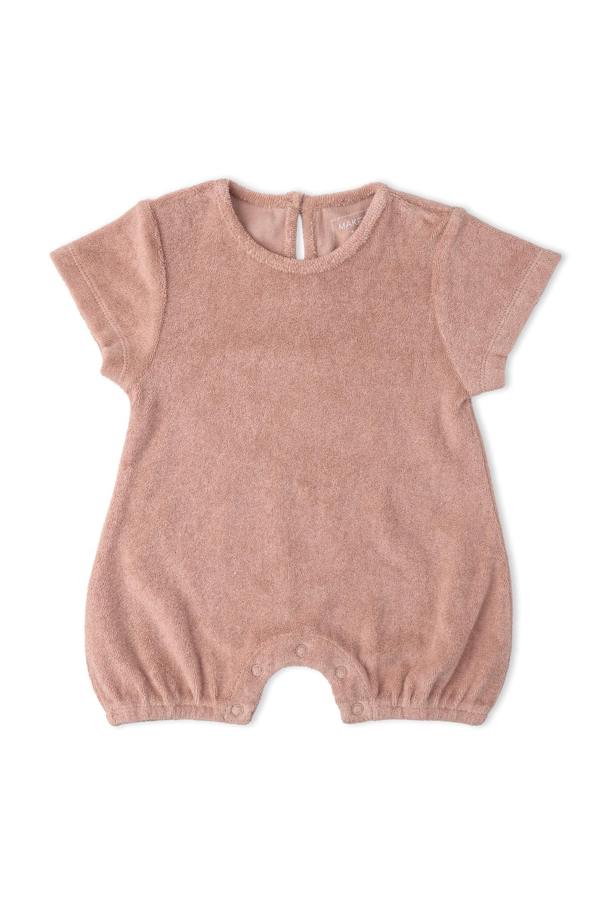 A soft clay-colored organic cotton short romper features short sleeves and a relaxed fit, ideal for warm weather and playful adventures. It includes snap closures for easy dressing.