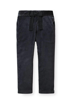 Black dressy pants for baby girls featuring a decorative bow at the waist and front pockets, made from organic cotton.