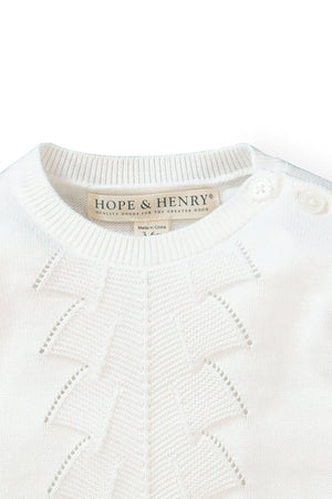 Close-up of a soft white organic cotton sweater gown from Hope & Henry, featuring delicate pointelle detailing and shoulder buttons.
