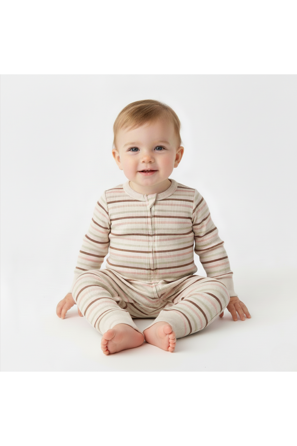 A baby sits comfortably in a soft, organic cotton romper featuring terra stripes. The romper has a button-up front and long sleeves, providing a cozy, breathable fit for delicate skin.