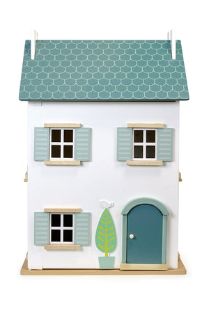 Model of a small house with a green roof and door on a white background