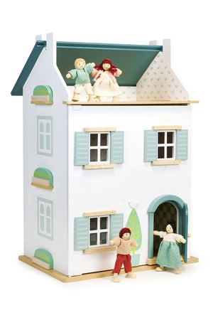 Toy dollhouse with miniature figures on a white background
