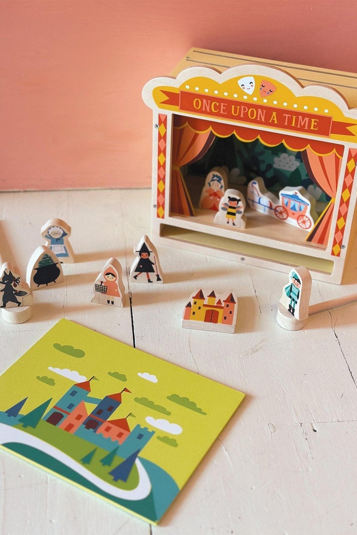 Wooden tabletop theatre with colorful characters and a Once Upon a Time stage, set on a white surface.